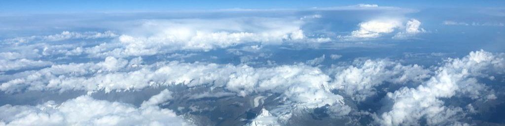 Cockpit View — Mountains and Clouds
